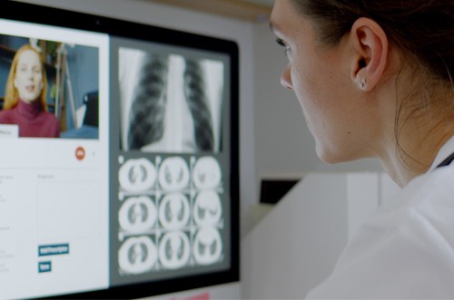 Caucasian female doctor delivering telemedicine consultation to a patient